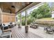 Outdoor patio area featuring a wooden picnic table, lounge seating, and a covered porch at 1422 Banbury Rd, Raleigh, NC 27607