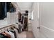 Bright walk-in closet with built in shelving, hanging racks, and a window for natural light at 1422 Banbury Rd, Raleigh, NC 27607