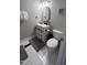 Bathroom featuring a new vanity, modern mirror, toilet, white tile flooring and neutral paint at 1436 Sedwick Rd, Durham, NC 27713