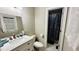 Modern bathroom with a new vanity, toilet, luxury shower curtain, and ample natural light at 1436 Sedwick Rd, Durham, NC 27713