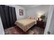 Cozy bedroom with plush bedding, neutral color palette, area rug, bedside table and a lamp at 1436 Sedwick Rd, Durham, NC 27713