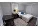 Comfortable bedroom with a metal bed frame, modern décor, and natural lighting, suitable for a relaxing retreat at 1436 Sedwick Rd, Durham, NC 27713