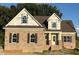 Exterior elevation showing a brick home with a gable roof, windows, and front entrance at 1611 S Old Carriage Rd, Rocky Mount, NC 27804