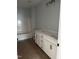 Bathroom featuring dual vanity with white cabinets and marble countertop, as well as tub with white tile surround at 200 Green Pines Estates Dr, Kenly, NC 27542