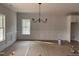 Dining room with wainscoting, chandelier, and large window at 200 Green Pines Estates Dr, Kenly, NC 27542