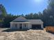 Newly constructed single-story home featuring a covered porch, attached garage, and freshly installed roof at 200 Green Pines Estates Dr, Kenly, NC 27542