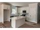 Bright kitchen featuring white cabinets, a stylish island, stainless steel appliances, and a window providing natural light at 200 Green Pines Estates Dr, Kenly, NC 27542