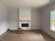 Cozy living room featuring an electric fireplace with shiplap accent wall, and a window providing natural light at 200 Green Pines Estates Dr, Kenly, NC 27542