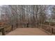 A wood deck overlooks a wooded backyard, perfect for relaxation at 208B Mallard Creek Dr, Graham, NC 27253