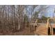 Elevated back deck overlooking a wooded backyard at 208B Mallard Creek Dr, Graham, NC 27253