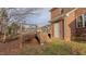 Wooden deck with stairs down to the yard and a view of brick home at 208B Mallard Creek Dr, Graham, NC 27253