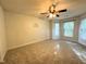 Spacious carpeted bedroom with ceiling fan, bay windows, and neutral paint at 208B Mallard Creek Dr, Graham, NC 27253