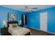 Cozy bedroom featuring blue walls, carpet, and essential furnishings at 208B Mallard Creek Dr, Graham, NC 27253