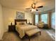 Bedroom with a bed, lamps, chair, bench, and natural light at 208B Mallard Creek Dr, Graham, NC 27253
