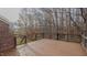 Spacious wooden deck with a metal and wood railing, overlooking the trees at 208B Mallard Creek Dr, Graham, NC 27253