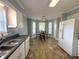 Kitchen featuring stainless steel sink, bay window, and refrigerator at 208B Mallard Creek Dr, Graham, NC 27253