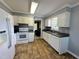 Kitchen featuring white cabinets, tile backsplash, and modern appliances at 208B Mallard Creek Dr, Graham, NC 27253
