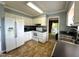 Kitchen with white appliances, cabinets, and view to the living area at 208B Mallard Creek Dr, Graham, NC 27253