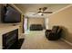 Living room with fireplace, ceiling fan, and access to the patio at 208B Mallard Creek Dr, Graham, NC 27253