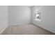 This vacant bedroom has a neutral carpet and a window with blinds at 2328 Beeblossom Pl, Fuquay Varina, NC 27526