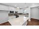 Spacious kitchen with white cabinets, stainless appliances, granite countertops, and center island at 2328 Beeblossom Pl, Fuquay Varina, NC 27526