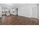 Open concept living area with hardwood floors connects kitchen and great room at 2328 Beeblossom Pl, Fuquay Varina, NC 27526