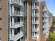Exterior shot showcasing multiple balconies with white railings, offering private outdoor spaces at 2402 Environ Way # Bldg 2000, Chapel Hill, NC 27517