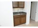 Built-in bar area featuring a granite countertop, sink, and glass-door cabinets at 2402 Environ Way # Bldg 2000, Chapel Hill, NC 27517