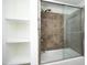 Bright bathroom with a tub and shower combo and built-in shelves, offering a clean design at 2402 Environ Way # Bldg 2000, Chapel Hill, NC 27517