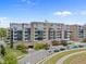 Exterior view of a modern apartment building with glass windows, beautiful landscaping and parking at 2402 Environ Way # Bldg 2000, Chapel Hill, NC 27517
