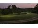Scenic golf course view featuring rolling greens, mature trees, and a paved cart path at dusk at 2402 Environ Way # Bldg 2000, Chapel Hill, NC 27517