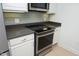 Updated kitchen with stainless steel appliances, gray subway tile, and white cabinetry at 2402 Environ Way # Bldg 2000, Chapel Hill, NC 27517
