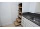 Kitchen offers white cabinets, pull-out shelves, and granite countertops at 2402 Environ Way # Bldg 2000, Chapel Hill, NC 27517