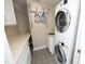 Functional laundry room with a stacked washer and dryer, sink, and storage, designed for convenience at 2402 Environ Way # Bldg 2000, Chapel Hill, NC 27517