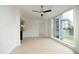 Spacious living room featuring large windows with view, hardwood floors, ceiling fan, and bar area at 2402 Environ Way # Bldg 2000, Chapel Hill, NC 27517