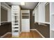 Walk-in closet with custom shelving and hardwood floors at 2402 Environ Way # Bldg 2000, Chapel Hill, NC 27517
