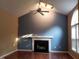 Bright living room with a fireplace, vaulted ceilings, and modern ceiling fan at 2416 Fields Of Broadlands Dr, Raleigh, NC 27604