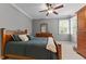Comfortable bedroom featuring a decorative ceiling fan, dresser, and a window with natural light at 255 Capellan St, Wake Forest, NC 27587