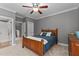 Neutral bedroom featuring carpet, gray walls and crown molding, complete with a wood bed and dresser at 255 Capellan St, Wake Forest, NC 27587