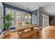 Sunny dining room with a rustic wooden table and views of the backyard at 255 Capellan St, Wake Forest, NC 27587