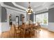 Elegant dining room featuring a wooden table, chandelier, and large windows at 255 Capellan St, Wake Forest, NC 27587