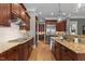 A kitchen with wood cabinets, granite countertops, stainless steel appliances, and hardwood floors at 255 Capellan St, Wake Forest, NC 27587