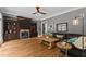 A living room with hardwood floors, a fireplace, built-in bookshelves, and a comfortable leather couch at 255 Capellan St, Wake Forest, NC 27587