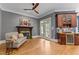 A living room with hardwood floors, a fireplace, wet bar, and french doors that lead to a patio at 255 Capellan St, Wake Forest, NC 27587