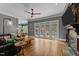 A living room with a fireplace, hardwood floors, and french doors that lead to a patio at 255 Capellan St, Wake Forest, NC 27587