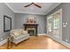 A living room with hardwood floors, a fireplace, and french doors that lead to a patio at 255 Capellan St, Wake Forest, NC 27587
