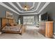 A main bedroom with a tray ceiling, carpeted floors, and two large windows at 255 Capellan St, Wake Forest, NC 27587