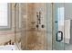 Elegant walk-in shower with decorative tile, bronze fixtures, and a seamless glass enclosure at 255 Capellan St, Wake Forest, NC 27587