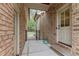 A convenient side entrance to the home with a brick walkway and gate at 255 Capellan St, Wake Forest, NC 27587