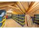 Spacious attic storage area featuring ample room and rows of storage containers with wooden rafters above at 257 Reese Dr, Willow Springs, NC 27592